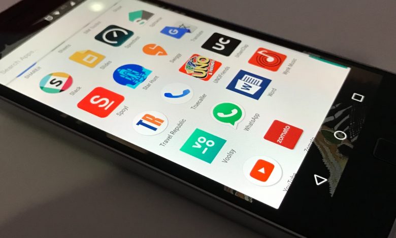 black Android smartphone lying on gray surface