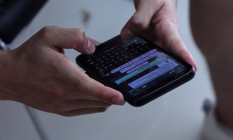 person holding black iphone 4