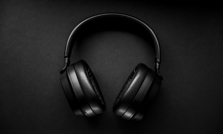black wireless headphones on black surface