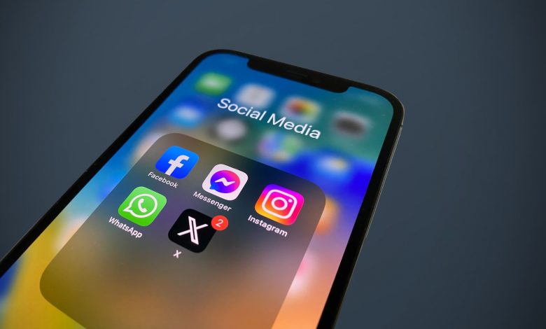 a close up of a cell phone with social media icons