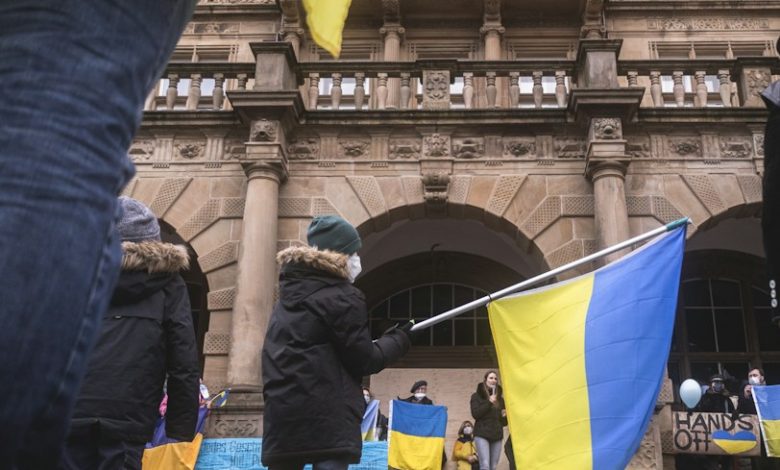 a group of people holding flags in front of a building