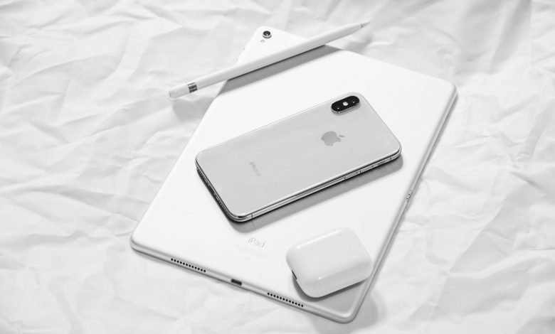 silver iPhone X with silver iPad