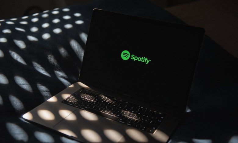 a laptop computer sitting on top of a bed