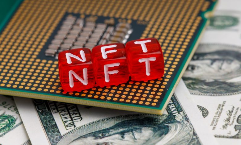 a close up of a small red block on top of a pile of money