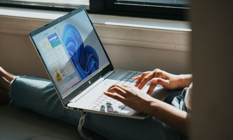 person using Windows 11 computer on lap