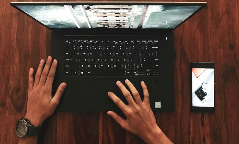 person holding black laptop computer