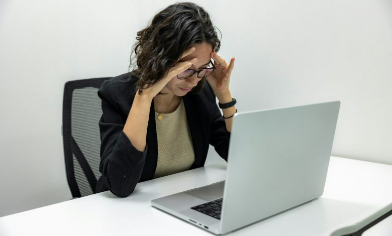 a woman sitting in front of a laptop computer